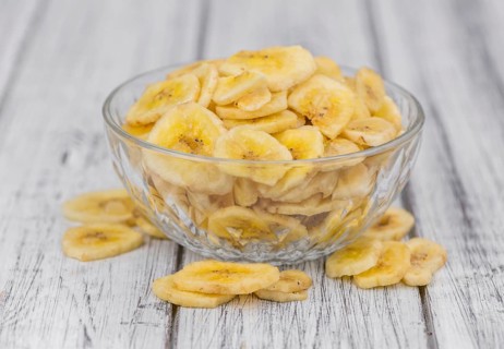 Fresh made Dried Banana Chips on an old and rustic wooden table, selective focus, close-up shot