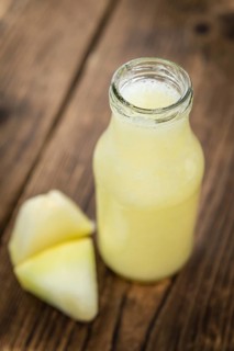 Homemade Honeydew Melon Smoothie on wooden background (selective focus)