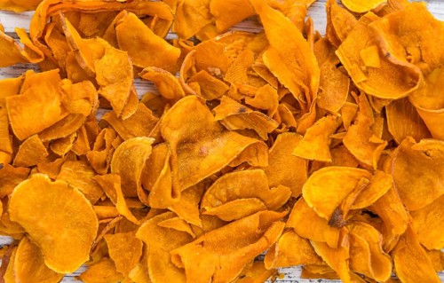 Sweet Potato Chips on a vintage background as detailed close-up shot, selective focus