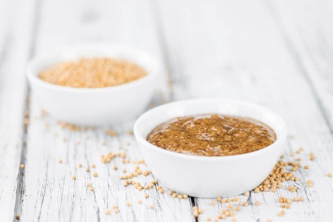 Fresh made German Cuisine (sweet Mustard) on a vintage background (close-up shot)