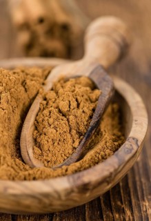 Fresh made Cinnamon Powder on a vintage background (close-up shot)