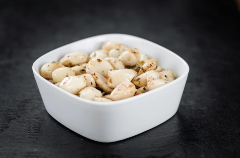 Marinated Garlic on a vintage slate slab (close-up shot, selective focus)