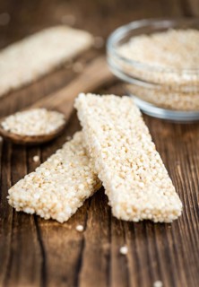 Quinoa Bars on a wooden table as detailed close-up shot (selective focus)