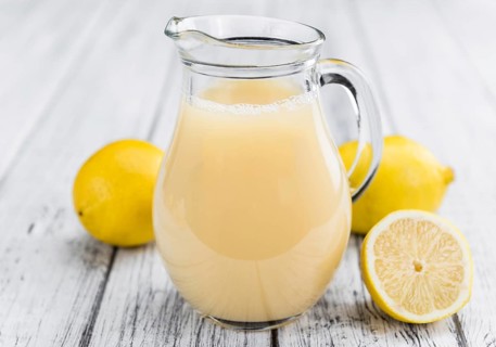 Fresh made Juice (lemon) on a vintage background (close-up shot)