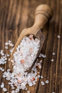 Himalayan Salt as high detailed close-up shot on a vintage wooden table (selective focus)