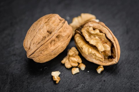 Walnuts on a vintage background as detailed close-up shot (selective focus)