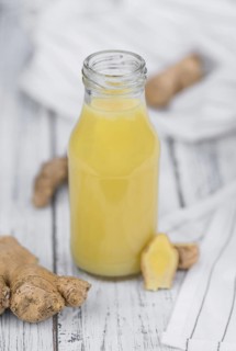Portion of healthy Ginger Drink (selective focus, close-up shot)