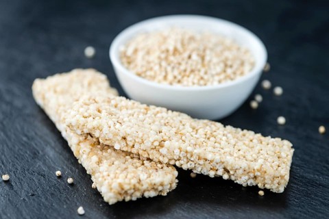 Some Quinoa Bars on a slate slab (close-up shot, selective focus)