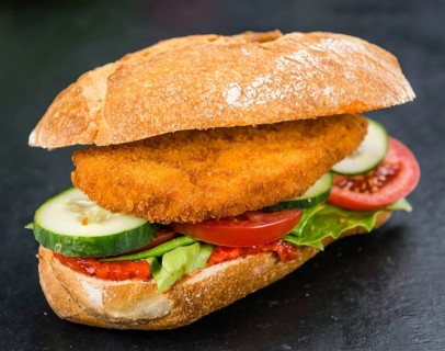 Slate slab with a Chicken Schnitzel (close-up shot, selective focus)