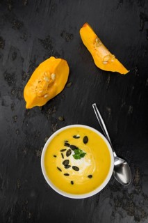 Homemade Pumpkin Soup (selective focus) on rustic background as close-up shot