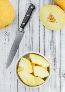 Fresh made Honeydew Melon on a vintage background (close-up shot)