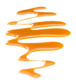 Caramel Sauce on a vintage slate slab (close-up shot, selective focus)