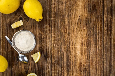 Vintage wooden table with Lemon powder (selective focus, close-up shot)