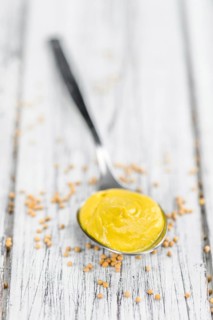 Mustard on a vintage background as detailed close-up shot (selective focus)