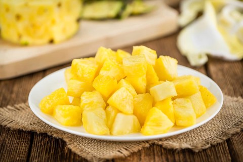 Fresh made Pineapple (sliced) on a vintage background as detailed close-up shot