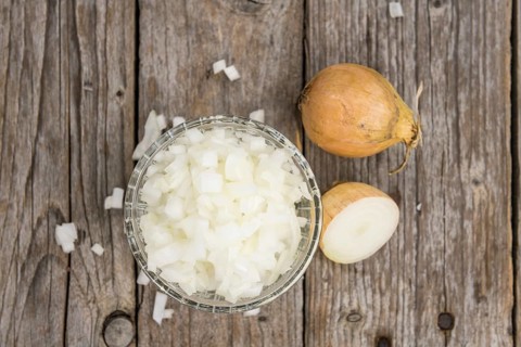 Diced white onions on a vintage background as detailed close-up shot, selective focus