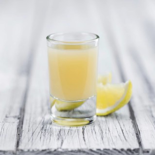 Fresh made Juice (lemon) on a vintage background (close-up shot)