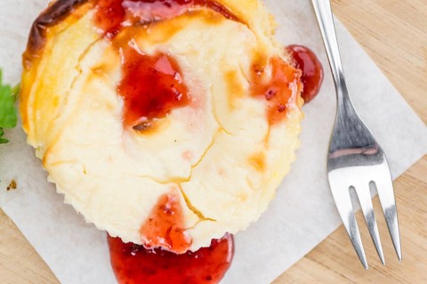 Cheesecake with berry Sacue on a vintage background as detailed close-up shot (selective focus)