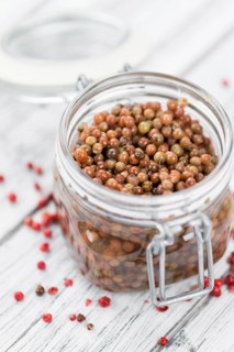 Portion of fresh preserved Pink Peppercorns close-up shot, selective focus