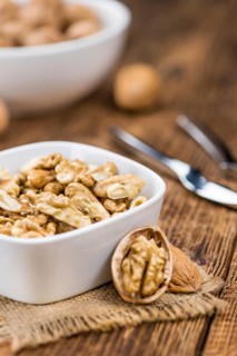 Walnut kernels on a vintage background as detailed close-up shot (selective focus)