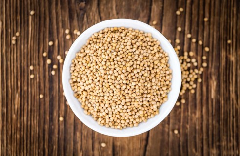 Seeds (Mustard) as high detailed close-up shot on a vintage wooden table (selective focus)