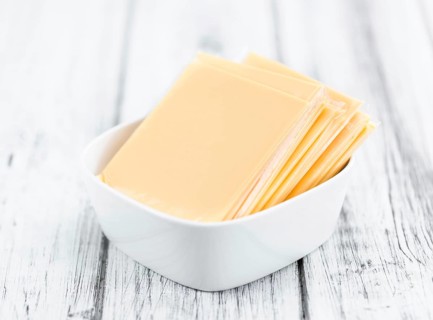 Portion of sliced Cheese (close-up shot, selective focus)