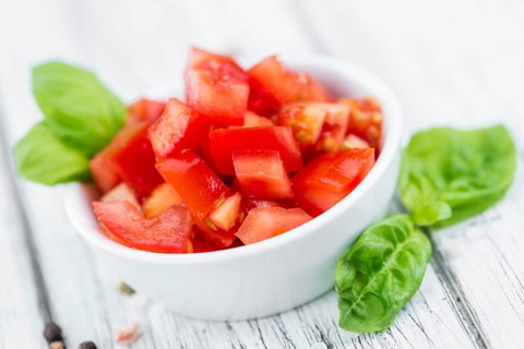 Homemade Cutted Tomatoes on vintage background (selective focus, close-up shot)