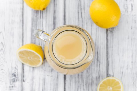 Lemon Juice on a vintage background as detailed close-up shot (selective focus)
