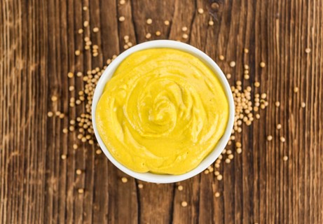 Mustard on a vintage background as detailed close-up shot (selective focus)