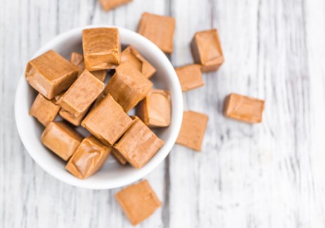 Caramel on a vintage background as detailed close-up shot (selective focus)