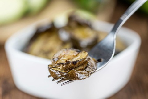 Homemade Antipasti (Grilled Zucchinis) on vintage background (selective focus, close-up shot)