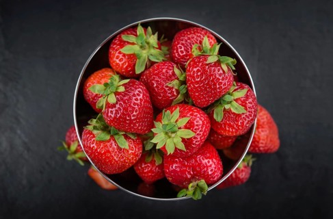 Some Strawberries on a slate slab as detailed close-up shot, selective focus