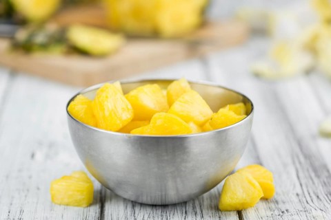 Fresh made Pineapple (sliced) on a vintage background as detailed close-up shot