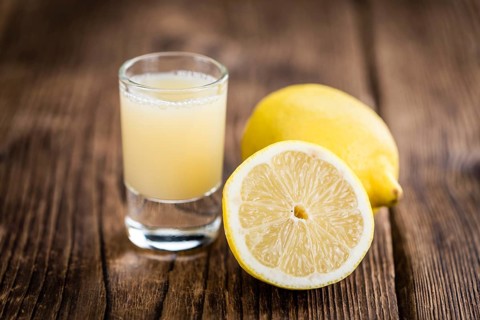 Fresh made Juice (lemon) on a vintage background (close-up shot)