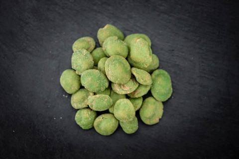 Portion of Wasabi coated Peanuts on a rustic slate slab (selective focus, close-up shot)