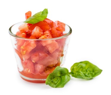 Portion of Diced Tomatoes (as close-up shot) isolated on white background