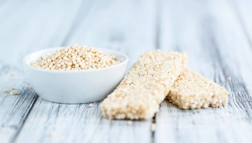 Quinoa Bars on a wooden table as detailed close-up shot (selective focus)