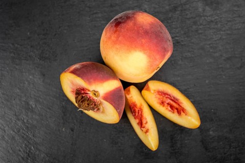 Some Peaches on a vintage slate slab, selective focus