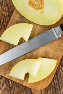 Fresh made Honeydew Melon on a vintage background (close-up shot)