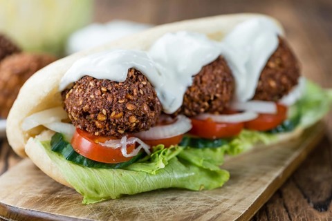 Falafel Sandwich (close-up shot) on an old wooden table