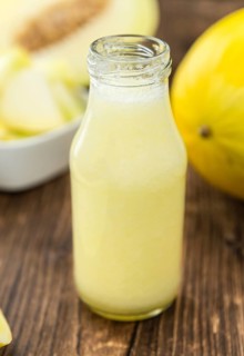 Healthy Honeydew Melon Smoothie (selective focus) on an old wooden table