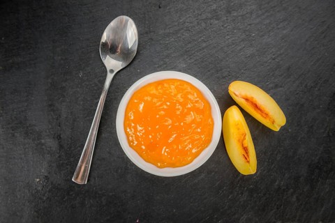 Portion of fresh Peach Jam close-up shot, selective focus