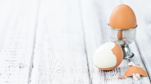 Wooden table with boiled Eggs (selective focus, close-up shot)