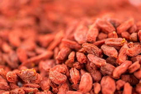 Goji Berries on a vintage background as detailed close-up shot (selective focus)