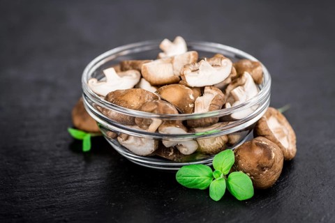 Portion of Shiitake mushrooms as detailed close up shot on a slate slab, selective focus