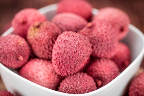 Lychees on a vintage background as detailed close-up shot (selective focus)