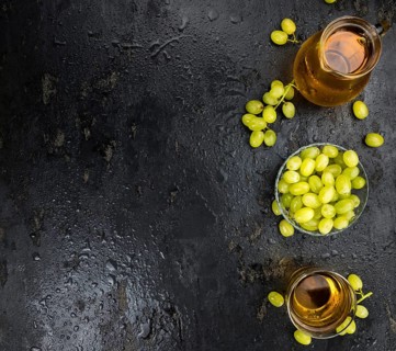 Some healthy Grape Juice on a vintage slate slab (selective focus)