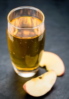 Fresh made Apple Cider on a vintage background (close-up shot)