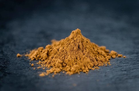 Fresh made Cinnamon Powder on a vintage background (close-up shot)
