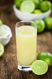 Lime Juice on a vintage background as detailed close-up shot (selective focus)